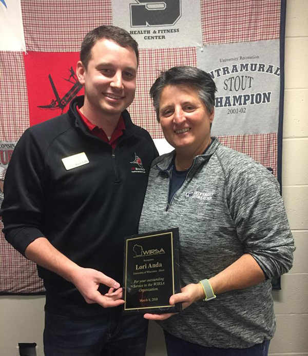 Lori Anda of UW-Stout receives her award from WIRSA Director Ryan Rudesill.