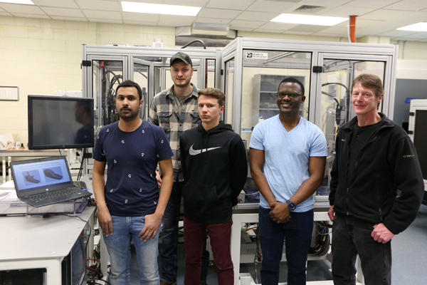 Professor Scott Springer, right, with his engineering capstone students.