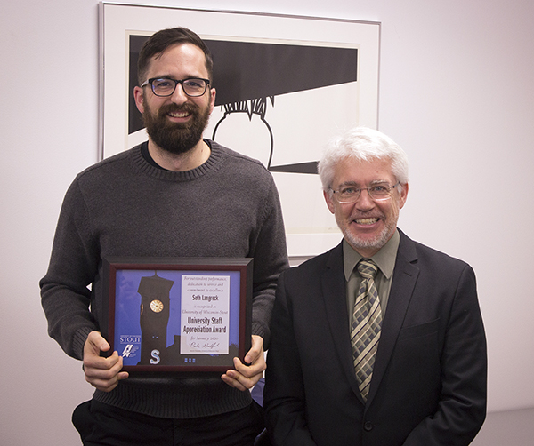 Seth Langreck, left, received the University Staff Employee Appreciation Award for January at UW-Stout from interim Chancellor Patrick Guilfoile.