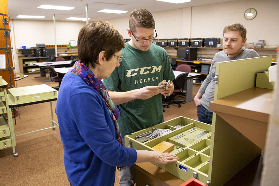 Professor Debra Homa, with graduate students Travis Mashuga and Josh Nielsen discuss a project as part of the rehabilitation and counseling assessment and planning class.