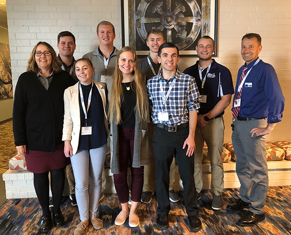 UW-Stout professors Debbie Stanislawski, left, and Urs Haltinner, right, attended a joint statewide business and marketing education conference with seven students. The students, from left, are Tanner Christopherson, Allison Rigotti, Ben Schwartz, Megan Weseli, Oliver Schroedl, Gavin Raph and Timothy Bott.