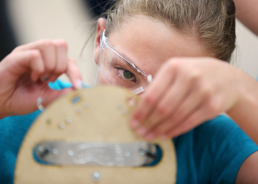 STEPS campers assemble robots. STEPS has added BOLD STEPS this year to help break gender stereotypes and build leadership skills in lab assistants and counselors.