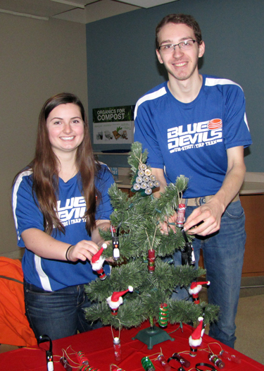 Clay Target Club members Hannah Brotzel and Eli Knott help sell holiday gifts made from used shotgun shells to raise money for the club.