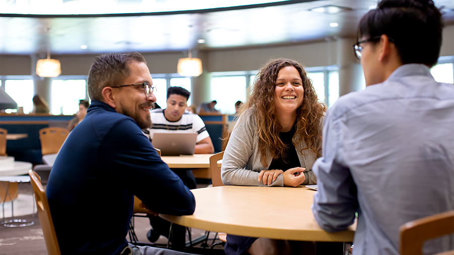 Dominique Vargas talks with a student, right, and Darren Ward, left, a first-year student adviser, at the UW-Stout student center. 