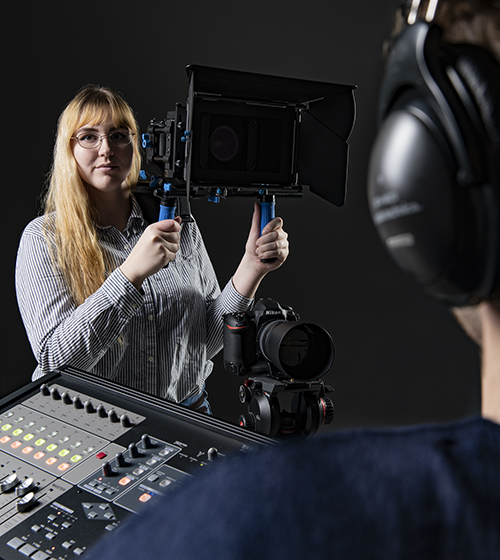 Student Olivia Mayasich helps set up a shot in video lab.