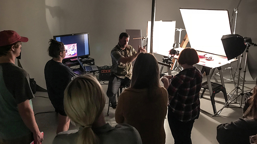 Guest speaker Chris Olson, a food photographer from Minneapolis, works with students.