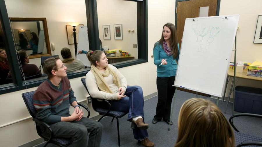 Students in the marriage and family therapy program work through a mock relationship counseling session in the Clinical Services Center on campus.