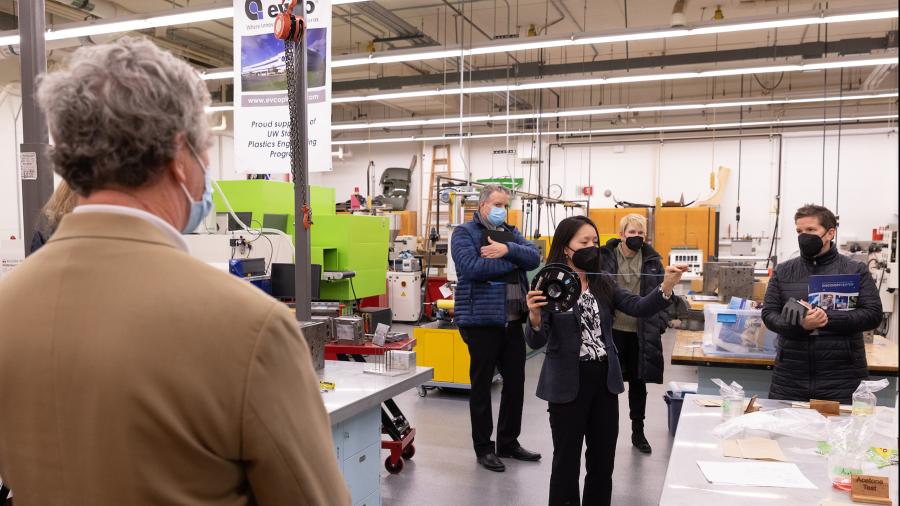 Professor Wei Zheng talks about the plastics engineering program during a tour for Missy Hughes, right. Listening are Randy Hulke and Chancellor Katherine Frank.