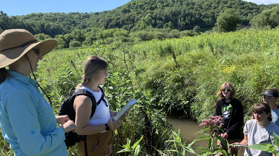 UW-Stout Assistant Professor Nicole Hayes, left, guides three high school students as they conduct tests on Gilbert Creek west of Menomonie.