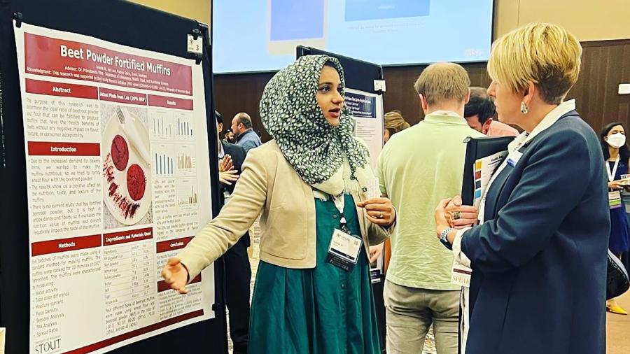 UW-Stout student Ali Areeba explains her research to Chancellor Katherine Frank during the Student Research Poster and Innovation Showcase as part of the WiSys Spark Symposium.