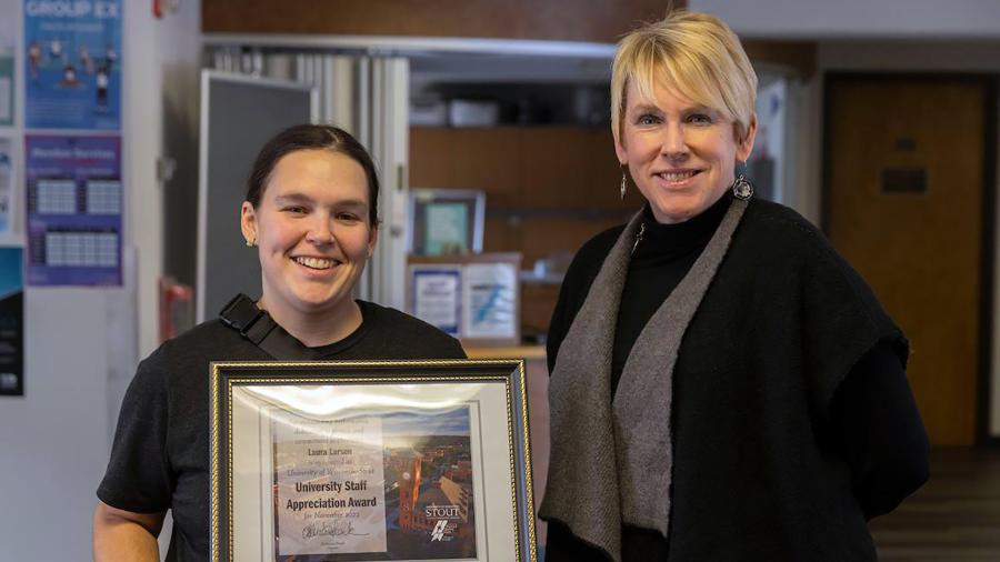 Laura Larsen, left, receives the November University Staff Employee Appreciation Award from Chancellor Katherine Frank.