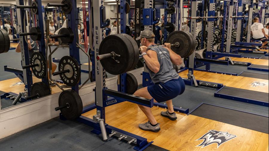 A Blue Devil student athlete uses the new weights in the Built by Hoeft Weight Room in the UW-Stout Sports and Fitness Center.