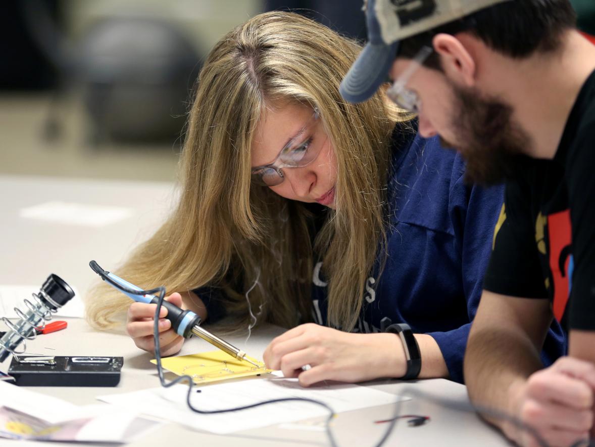 Technology education students Beth Rocque and Zak Kachel learn to solder electronic circuit components in the tech ed lab.
